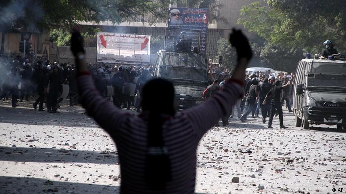 Egyptian security forces, background, clash with protesters near Tahrir Square in Cairo, Egypt, Sunday, Nov. 25, 2012. (Photo: AP)