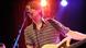 Stephen Malkmus sings into a microphone on stage Stephen Malkmus sings into a microphone on stage