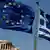 A European Union left and the Greek flag wave above the ancient Parthenon temple