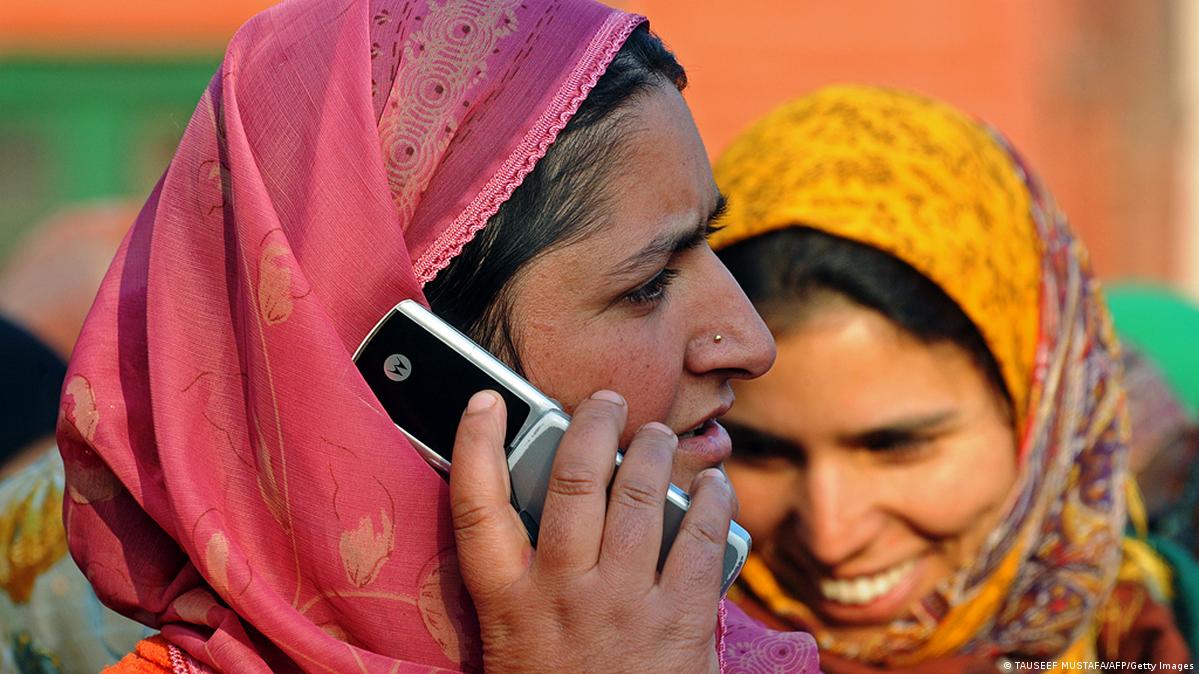 A woman in Srinagar, Kashmir on a cell phone 