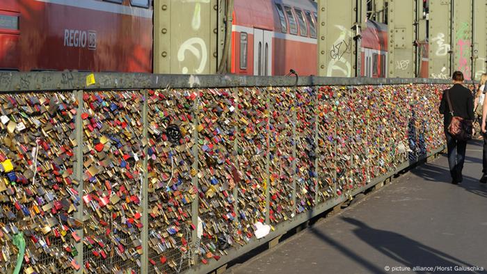 Thousands of padlocks hang from the frame of the Hohenzollern Bridge in Cologne