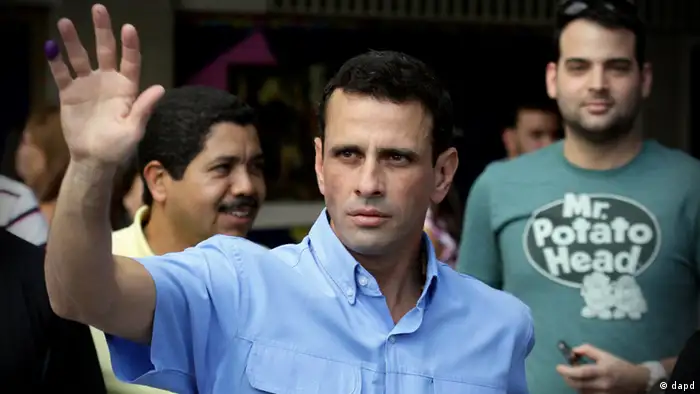 Miranda's Gov. Henrique Capriles waves to supporters after casting his ballot at a polling station in Caracas, Venezuela, Sunday, Dec. 16, 2012. Venezuelans are choosing governors and state lawmakers in elections that have become a key test of whether President Hugo Chavez's movement can endure if the socialist leader leaves the political stage. (AP Photo/Fernando Llano)