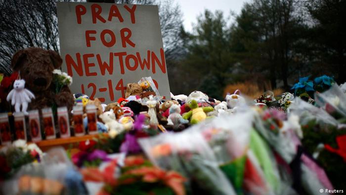 Flowers, candles and stuffed animals are seen at a makeshift memorial in Newtown, Connecticut December 17, 2012. Two funerals on Monday ushered in what will be a week of memorial services and burials for the 20 children and six adults massacred at Sandy Hook Elementary School in Newtown. REUTERS/Eric Thayer (UNITED STATES - Tags: CRIME LAW OBITUARY)