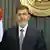 In this image released by the Egyptian Presidency, President Mohammed Morsi prepares to make a televised address to the nation in Cairo, Egypt, Wednesday, Dec. 26, 2012. Morsi says the new constitution establishes Egypt's new republic, calling on opposition to join dialogue to heal rifts and shift the focus toward repairing the economy.(Foto:Egyptian Presidency/AP/dapd)