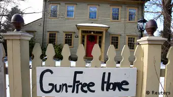 A Gun-FreeHome sign is seen in front of a house along the route to the Chalk Hill School where the Sandy Hook Elementary School children will begin to attend classes in Monroe, Connecticut, January 2, 2013. The repurposed school is having an open house today and will begin hosting classes tomorrow.