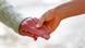 An older hand holds a younger hand. An older hand holds a younger hand.