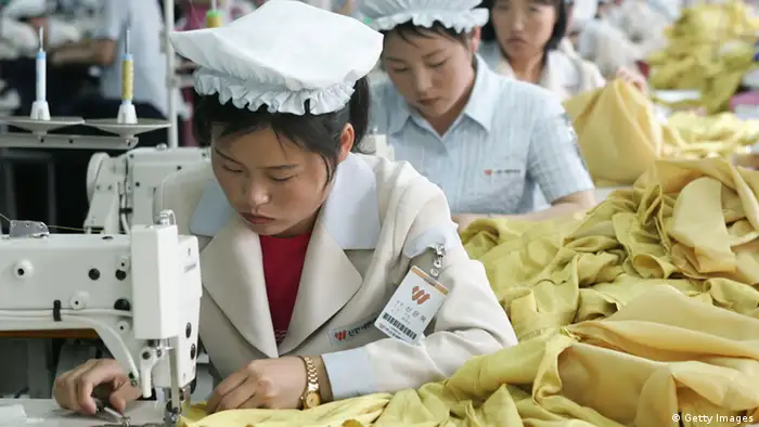 KAESONG, NORTH KOREA - MAY 22: North Korean women work at the assembly line of the factory of South Korean textile company ShinWon at the Kaesong industrial complex on May 22, 2007 in Kaesong, North Korea. 300 South Korean companies, mostly labour-intensive manufacturers, are waiting to build their factories on the site by the end of 2007, just 10 km north of the world's most heavily fortified border bisecting the two Koreas. They plan to hire more than 100,000 North Koreans to make products ranging from shoes and watches, clothes, according to officials from Kaesong industrial complex. About 2,000 South Korean companies have applied to move their production facilities into the Kaesong complex, where they can pay only one-thirtieth of the monthly wage per worker they pay at home or half the pay even in China. (Photo by Chung Sung-Jun/Getty Images)