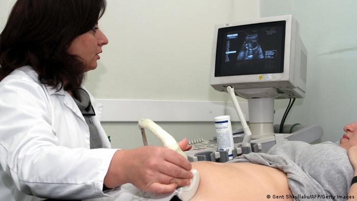 A pregnant Albanian woman watches her baby in the monitor as a doctor performs a sonogram in Tirana on November 9, 2011. In Albania, abortion was legalised on the eve of the Communist regime's fall in the 1990s. Since then, it has become almost a favourite method to chose the sex of its child, several local rights groups warn. According to a law adopted in April 2002, sex-selective abortion is forbidden, but there are no specific sanctions for breaching the law, experts say. AFP PHOTO / GENT SHKULLAKU (Photo credit should read GENT SHKULLAKU/AFP/Getty Images)
