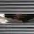 Einbrecher mit einer Taschenlampe sieht durch ein Fenster © imageteam #10661737