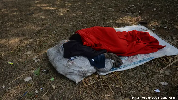 A Bangladeshi wraps himself in a blanket as he rests in a park in Dhaka on January 10, 2013. Around 80 people have died in the past week due to cold related diseases such as pneumonia as mercury dropped to the lowest in tropical Bangladesh's history, officials said Thursday. Weather and Red Crescent Society officials said the toll was expected to grow as the cold wave that's been sweeping the country for the last week was set to linger two more days, affecting a quarter of the country's 153 million people. AFP PHOTO/Munir uz ZAMAN (Photo credit should read MUNIR UZ ZAMAN/AFP/Getty Images)