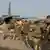 French troops prepare to board a transport plane in N'Djamena, Chad, in this photo released by the French Army Communications Audiovisual office (ECPAD) on January 12, 2013. French forces carried out a second day of air strikes against Islamist rebels in Mali on Saturday and sent troops to protect the capital Bamako in an operation involving several hundred soldiers, Defence Minister Jean-Yves Le Drian said. REUTERS/ECPAD/Adj. Nicolas Richard/Handout (CHAD - Tags: POLITICS MILITARY) NO SALES. NO ARCHIVES. ATTENTION EDITORS - THIS IMAGE WAS PROVIDED BY A THIRD PARTY. FOR EDITORIAL USE ONLY. NOT FOR SALE FOR MARKETING OR ADVERTISING CAMPAIGNS. THIS PICTURE IS DISTRIBUTED EXACTLY AS RECEIVED BY REUTERS, AS A SERVICE TO CLIENTS