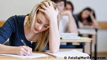 Student working on homework in classroom © Moritz Wussow #28634921