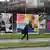 Woman walking past election billboards Foto: Nigel Treblin/dapd