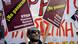A man holds signs during a demonstration in response to the killing of 27-year-old Pakistani migrant who was a victim of an alleged racism-fuelled crime on January 19, 2013 in Athens, Greece. Photo by Milos Bicanski/Getty Images A man holds signs during a demonstration in response to the killing of 27-year-old Pakistani migrant who was a victim of an alleged racism-fuelled crime on January 19, 2013 in Athens, Greece. Photo by Milos Bicanski/Getty Images