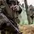 Schwer bewaffnete FARC Rebellen (Foto: dpa)