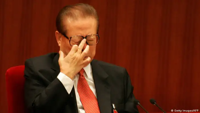 Former President Jiang Zemin adjusts his glasses at the opening session of the ruling Communist Party's five-yearly congress, 15 October 2007 at the Great Hall of the People in Beijing. President Hu Jintao opened China's biggest political event with pledges to curb the worst excesses of breakneck economic growth and implement cautious political reforms while addressing the ruling Communist Party's elite, gathered for their five-yearly Congress, with Hu acknowledging that China's modernisation drive since the late 1970s had also caused huge environmental and social problems. AFP PHOTO/Frederic J. BROWN (Photo credit should read FREDERIC J. BROWN/AFP/Getty Images)