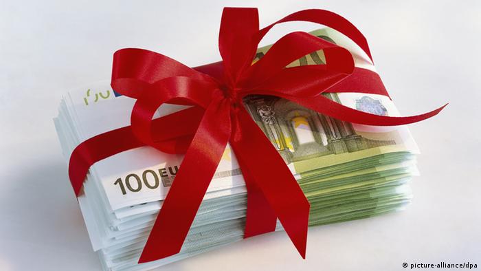 Bundle of banknotes tied with red ribbon