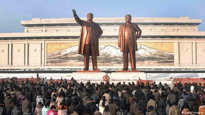 This picture taken by North Korea's official Korean Central News Agency on December 17, 2012 shows crowds of people visiting the Mansu Hill in Pyongyang before statues of late President Kim Il-Sung and leader Kim Jong-Il on the first anniversary of leader Kim Jong-Il's death. North Korea on December 17 mourned the death one year ago of leader Kim Jong-Il, with its rocket scientists taking pride of place at a mass memorial ceremony led by his son and successor Kim Jong-Un. AFP PHOTO / KCNA via KNS ---EDITORS NOTE--- RESTRICTED TO EDITORIAL USE - MANDATORY CREDIT AFP PHOTO / KCNA VIA KNS - NO MARKETING NO ADVERTISING CAMPAIGNS - DISTRIBUTED AS A SERVICE TO CLIENTS (Photo credit should read KNS/AFP/Getty Images)
