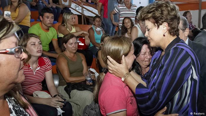 Brazil's President Dilma Rousseff (R) consoles relatives of victims of a fire which occurred at the Boate Kiss nightclub in the southern city of Santa Maria, 187 miles (301 km) west of the state capital of Porto Alegre, January 27, 2013. A fire in a nightclub killed at least 245 people in southern Brazil on Sunday when a band's pyrotechnics show set the building ablaze and fleeing patrons were unable to find the emergency exits in the ensuing panic, officials said. Bodies were still being removed from the Kiss nightclub in the southern city of Santa Maria, Major Gerson da Rosa Ferreira, who was leading rescue efforts at the scene for the military police, told Reuters. REUTERS/Roberto Stuckert Filho/Brazilian Presidency/Handout (BRAZIL - Tags: DISASTER POLITICS) ATTENTION EDITORS -THIS IMAGE WAS PROVIDED BY A THIRD PARTY. FOR EDITORIAL USE ONLY. NOT FOR SALE FOR MARKETING OR ADVERTISING CAMPAIGNS. THIS PICTURE IS DISTRIBUTED EXACTLY AS RECEIVED BY REUTERS, AS A SERVICE TO CLIENTS