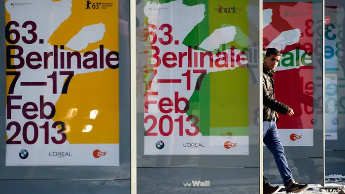 A pedestrian walks behind advertising banners for the upcoming 63rd Berlinale film festival in Berlin January 25, 2013. The Berlinale film festival runs from February 7 to 17 in the German capital. REUTERS/Fabrizio Bensch (GERMANY - Tags: ENTERTAINMENT)