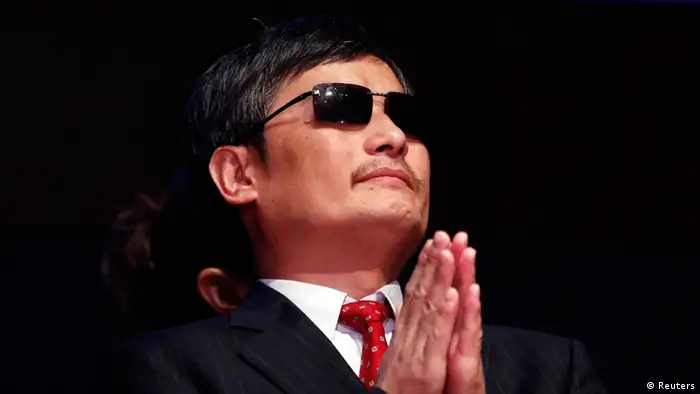 Chinese dissident Chen Guangcheng listens to remarks during a ceremony awarding him The Tom Lantos Human Rights Prize in the Capitol in Washington January 29, 2013. Behind Chen is a translator. REUTERS/Kevin Lamarque (UNITED STATES - Tags: POLITICS)