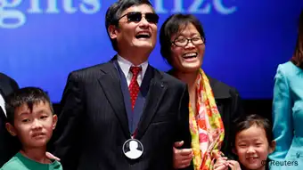 Chinese dissident Chen Guangcheng, his wife Yuan Weijing and their children appear onstage after Chen received The Tom Lantos Human Rights Prize in the Capitol in Washington January 29, 2013. REUTERS/Kevin Lamarque (UNITED STATES - Tags: POLITICS TPX IMAGES OF THE DAY)