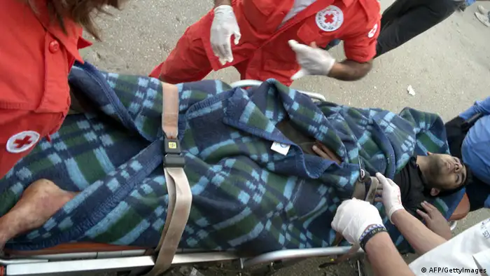 An injured Syrian man is wheeled on a stretcher by Lebanese Red Cross medical personnel after being smuggled into the northern Lebanese town of Wadi Khaled, bordering with Syria to be treated in Lebanon on May 30, 2012. An estimated 24,000 Syrians have sought refuge in Lebanon, mostly in the northern region of Wadi Khaled, after Assad began using force to crush a popular uprising that erupted in March 2011. AFP PHOTO / STR (Photo credit should read -/AFP/GettyImages)