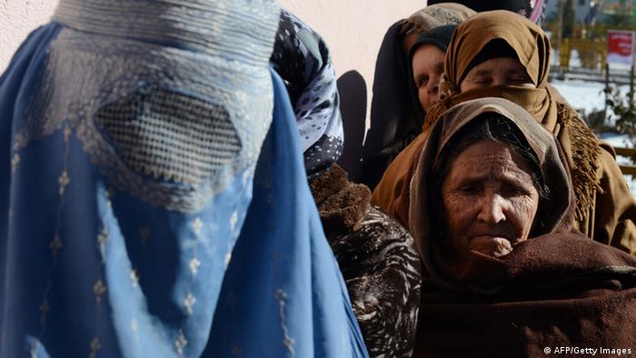 Afghan women line up to receive winter supplies at a UNHCR distribution centre for needy refugees at the Women's Garden in Kabul on January 2, 2013. (Photo: read SHAH MARAI/AFP/Getty Images)