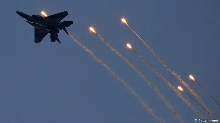 An Israeli F-15 I fighter jet launches anti-missile flares during an air show at the graduation ceremony of Israeli pilots at the Hatzerim air force base in the Negev desert, near the southern Israeli city of Beersheva, on December 27, 2012. AFP PHOTO / JACK GUEZ (Photo credit should read JACK GUEZ/AFP/Getty Images)
