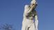 A statue of a man covering his face in Paris A statue of a man covering his face in Paris
