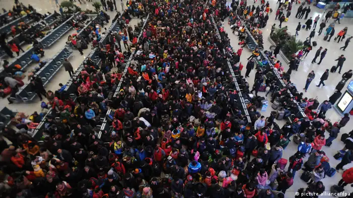 A crowd of Chinese passengers on their way back for the Spring Festival or the Chinese New Year queue up to check in at the Shenyang North Railway Station in Shenyang city, northeast Chinas Liaoning province, 26 January 2013. Chinese authorities added extra travel contingencies to ensure the smooth kick-off on Saturday (26 January 2013) of the worlds largest annual migration that starts before the Lunar New Year. Railway authorities arranged 358 more passenger trains on Saturday to start handling the estimated 5.2 million daily trips over the next 40 days peak travel season, said Zhao Chunlei, an official with the Ministry of Railways. A record 3.41 billion trips are expected to be made over this years Lunar New Year travel rush, as Chinese who have worked away from home see the holiday as the most important occasion for family reunion. The countrys rail network is expected to handle 225 million trips, while long-distance buses will see up to 3.1 billion passengers, which combine to account for 99 percent of the overall national capacity, according to the National Development and Reform Commission.