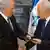 Israeli Prime Minister Benjamin Netanyahu (L) receives a folder from Israeli President Simon Peres (R) in a brief ceremony in the president' Jerusalem residence (EPA/JIM HOLLANDER / POOL)