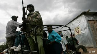 Kenyan police escort locals inside a van.