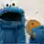 The blue cookie monster poses with a cookie. Photo: Georg Wendt/dpa