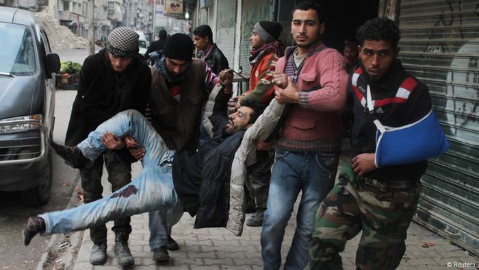 Free Syrian Army fighters and civilians transport a wounded man into a hospital in Aleppo's al-Shaar district after what activists said was from a ground-to ground missile attack by forces loyal to Syria's President Bashar al-Assad at Aleppo's Hanano district, February 8, 2013. REUTERS/Saad AbuBrahim (SYRIA - Tags: POLITICS CIVIL UNREST TPX IMAGES OF THE DAY)