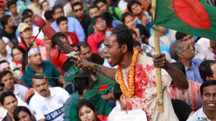 People attend a mass demonstration at Shahbagh intersection, demanding capital punishment for Bangladesh's Jamaat-e-Islami senior leader Abdul Quader Mollah, after a war crimes tribunal sentenced him to life imprisonment, in Dhaka February 8, 2013. About 100,000 people rallied in Bangladesh's capital on Friday to vent their anger at the country's feuding politicians, the fourth day of protests after an Islamist leader convicted of war crimes was spared execution. Most Bangladeshis had expected a death sentence to be handed to Mollah, 64, assistant secretary-general of Jamaat-e-Islami - the country's biggest Islamist party. REUTERS/Andrew Biraj (BANGLADESH - Tags: CIVIL UNREST POLITICS CRIME LAW)