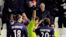 Referee Paolo Tagliavento (R) shows a red card to PSG's Swedish forward Zlatan Ibrahimovic (L) during the UEFA Champions League round of 16 first leg football match Valencia CF vs Paris Saint Germain at the Mestalla stadium in Valencia on February 12, 2013. AFP PHOTO/ JOSEP LAGO (Photo credit should read JOSEP LAGO/AFP/Getty Images)