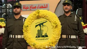 Members of militant Shiite Muslim group Hezbollah carry a wreath on the occasion of the party's Martyrs' Day in southern Beirut, on November 12, 2012. AFP PHOTO / ANWAR AMRO (Photo credit should read ANWAR AMRO/AFP/Getty Images)
