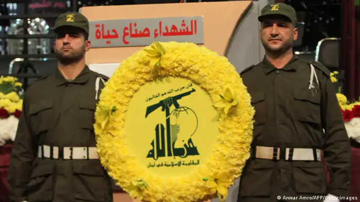 Members of militant Shiite Muslim group Hezbollah carry a wreath on the occasion of the party's Martyrs' Day in southern Beirut, on November 12, 2012. AFP PHOTO / ANWAR AMRO (Photo credit should read ANWAR AMRO/AFP/Getty Images)