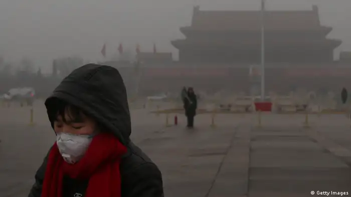 BEIJING, CHINA - JANUARY 31: A tourist wearing the masks walks on the Tiananmen Square during severe pollution on January 31, 2013 in Beijing, China. Heavy smog that has choked Beijing for the last five days weakened slightly on Thursday due to a light rainfall, although the capital's air remains heavily polluted. The haze choking many Chinese cities covers a total area of 1.43 million square kilometers, the China's Ministry of Environmental Protection said Wednesday. (Photo by Feng Li/Getty Images)
