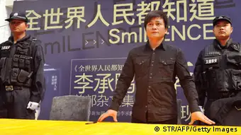 Chinese writer Li Chengpeng, looked upon by many as a a highly influential Chinese blogger and social commentator, attends a promotional event of his new book SmILENCE on January 26, 2013 in Kunming, southwest China's Yunnan province. Li was attacked by Maoists earlier at his book signings in Beijing and Shenzhen, forcing him to cancel two others in Guangzhou and Changsha. The Maoists take offence to Li's caustic essays and comments about the Communist Party?s governance. Li has previously been punched in the head at a previous signing. CHINA OUT AFP PHOTO (Photo credit should read STR/AFP/Getty Images)