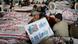 A Shi'ite Muslim man holds a sign as he sits beside covered bodies of those killed in Saturday's bomb attack, during a protest in Quetta February 19, 2013. Pakistani Shi'ites agreed to bury those killed in the most recent sectarian bombing, ending four days of protests, after the government said on Tuesday it had arrested 170 suspects linked to the attack. REUTERS/Naseer Ahmed (PAKISTAN - Tags: POLITICS CIVIL UNREST CRIME LAW RELIGION) A Shi'ite Muslim man holds a sign as he sits beside covered bodies of those killed in Saturday's bomb attack, during a protest in Quetta February 19, 2013. Pakistani Shi'ites agreed to bury those killed in the most recent sectarian bombing, ending four days of protests, after the government said on Tuesday it had arrested 170 suspects linked to the attack. REUTERS/Naseer Ahmed (PAKISTAN - Tags: POLITICS CIVIL UNREST CRIME LAW RELIGION)
