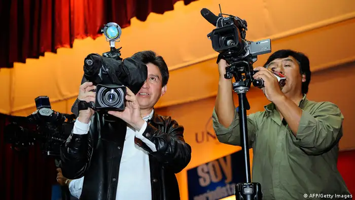 Cameramen shoot the press conference of Investigative journalists and authors of 'Gran Hermano' (Big Brother), Juan Carlos Calderón and Christian Zurita for the release of their book, in Quito, on March 24, 2011 (photo: RODRIGO BUENDIA/AFP/Getty Images).