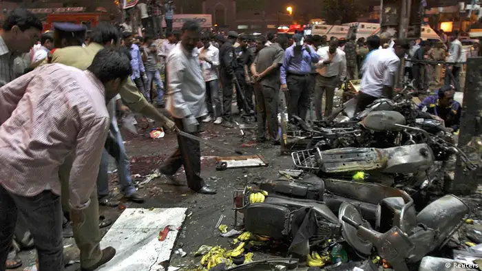 Police examine the site of an explosion at Dilsukh Nagar in the southern Indian city of Hyderabad February 21, 2013. Two bombs placed on bicycles exploded in a crowded market-place in Hyderabad on Thursday, and the federal home minister said at least 11 people were killed and 50 wounded. REUTERS/Krishnendu Halder (INDIA - Tags: CIVIL UNREST DISASTER)