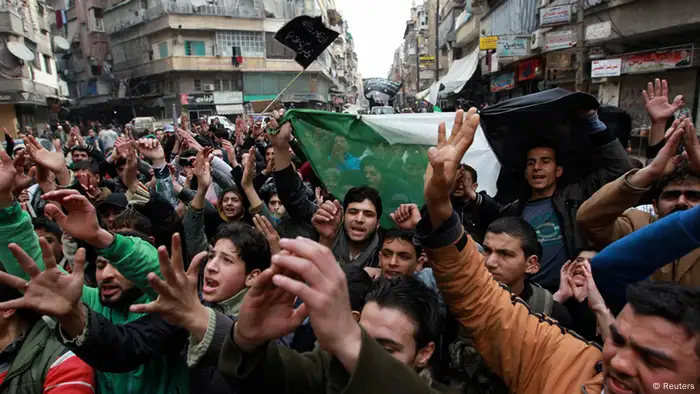 Demonstrators chant slogans and wave Syrian opposition flags during a protest against Syria's President Bashar al-Assad in Bustan al-Qasr district in Aleppo February 22, 2013. REUTERS/Muzaffar Salman (SYRIA - Tags: CONFLICT POLITICS CIVIL UNREST)