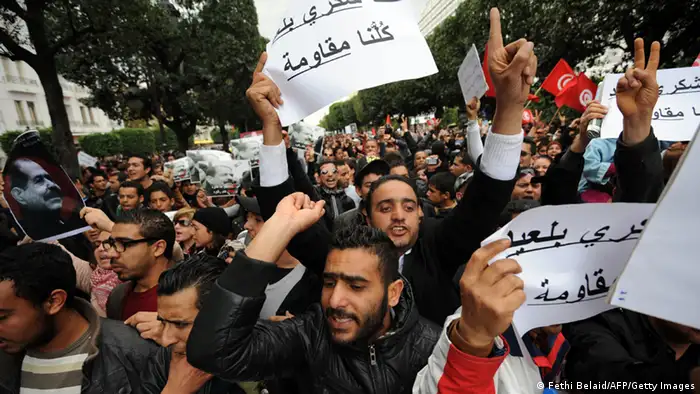 Tunisian protesters hold placards shouting slogans during a demonstration on February 23, 2013 on the Habib Bourguiba Avenue in Tunis. Hundreds of demonstrators marched to protest against the Islamist party Ennahda in power, and demanded that opposition leader Chokri Belaid's killers be found. AFP PHOTO / FETHI BELAID (Photo credit should read FETHI BELAID/AFP/Getty Images)