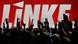 Zur Abstimmung erhobene Hände mit der Inschrift "Die Linke" im Hintergrund" - Foto: Martin Schutt (Foto: dpa) Zur Abstimmung erhobene Hände mit der Inschrift "Die Linke" im Hintergrund" - Foto: Martin Schutt (Foto: dpa)