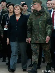 Germany's Chancellor Angela Merkel is escorted by commander of German troops in Turkey Colonel Marcus Ellermann (R) as she arrives at a Turkish military base to meet with NATO German Patriot missile batteries' troops in Kahramanmaras February 24, 2013. REUTERS/Murad Sezer (TURKEY - Tags: POLITICS MILITARY)