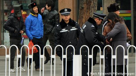 Police search people outside the Great Hall of the People before the opening session at the 11th National Committee of the Chinese People's Political Consultative Conference (CPPCC) in Beijing on March 3, 2012. China's parliament, also called the National People's Congress (NPC), will open its last annual session under the current leadership on March 5, amid what analysts say may be a bitter power struggle to replace outgoing Communist Party rulers. AFP PHOTO / Mark RALSTON (Photo credit should read MARK RALSTON/AFP/Getty Images) 