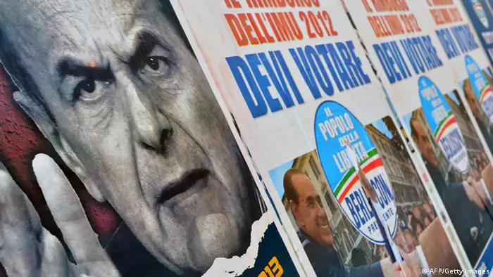 Electoral placards showing Democratic Party (PD) leader Pier Luigi Bersani (L) and right-wing Silvio Berlusconi are displayed on a wall in Rome on February 26, 2013. Italy was at an impasse Tuesday after an election seen as crucial for the eurozone failed to produce a clear winner and provided a shock debut for a populist anti-austerity party, rattling world markets and setting off alarm bells across Europe. AFP PHOTO / GABRIEL BOUYS (Photo credit should read GABRIEL BOUYS/AFP/Getty Images)